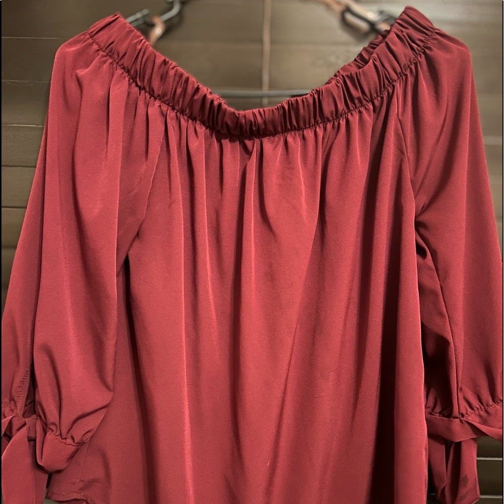 Small, off shoulder, burgundy top.